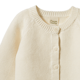 Cream organic cotton Pepi Cardigan with garter stitch knit and corozo nut buttons.